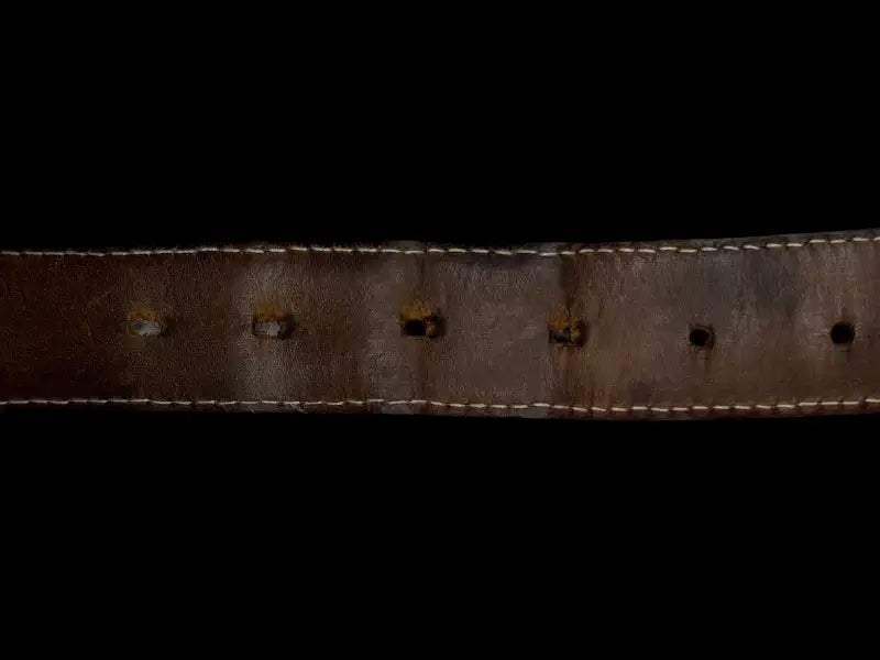 Worn out traditional belt with holes